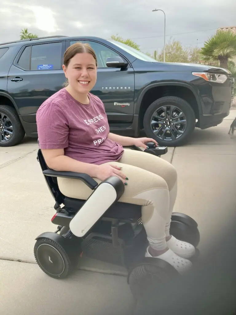 A woman sitting on an electric wheel chair