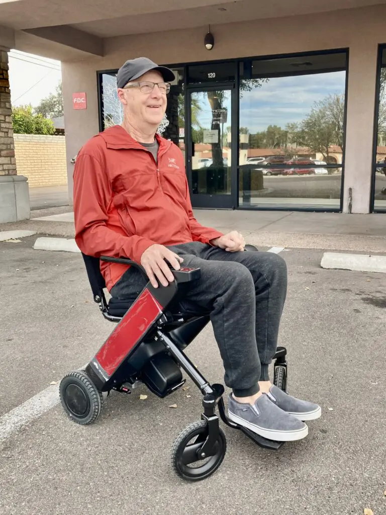 A senior man sitting on an electric wheel chair