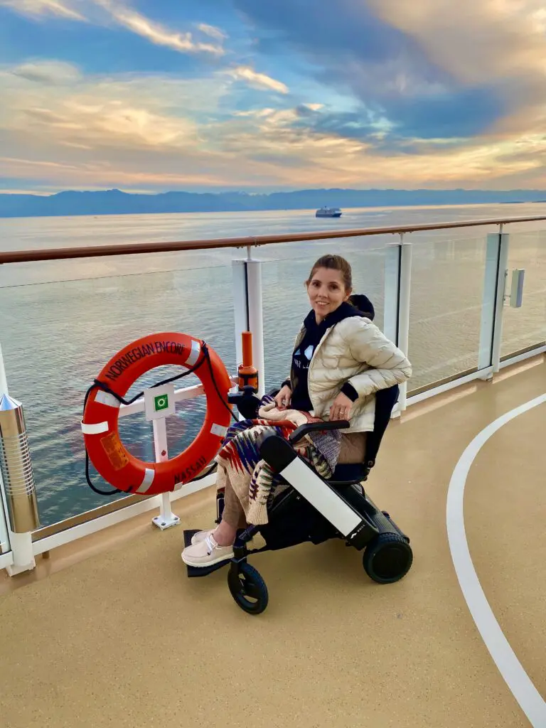 A woman sitting on a wheel chair at a ship