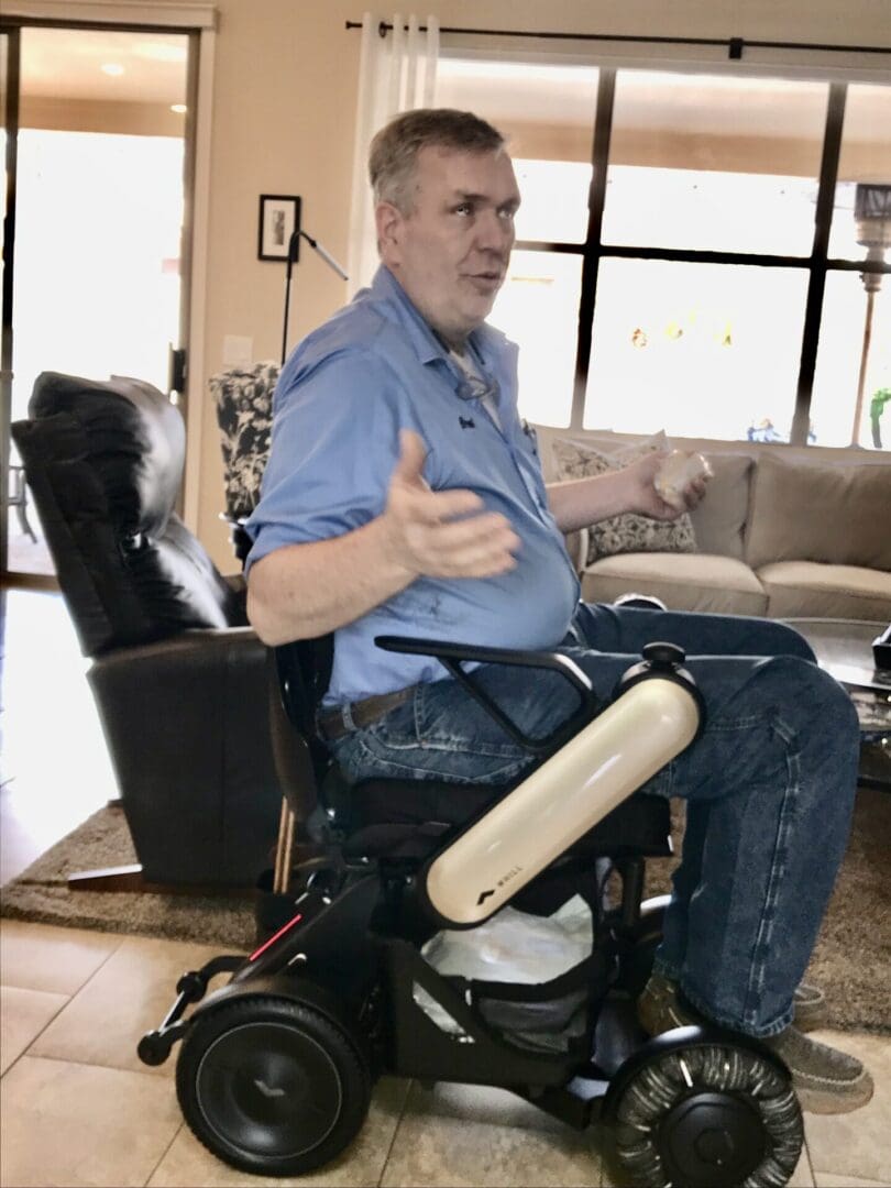 A man in a wheelchair in a living room.