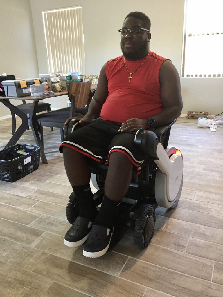 A person in his causal wear sitting on a mobility device