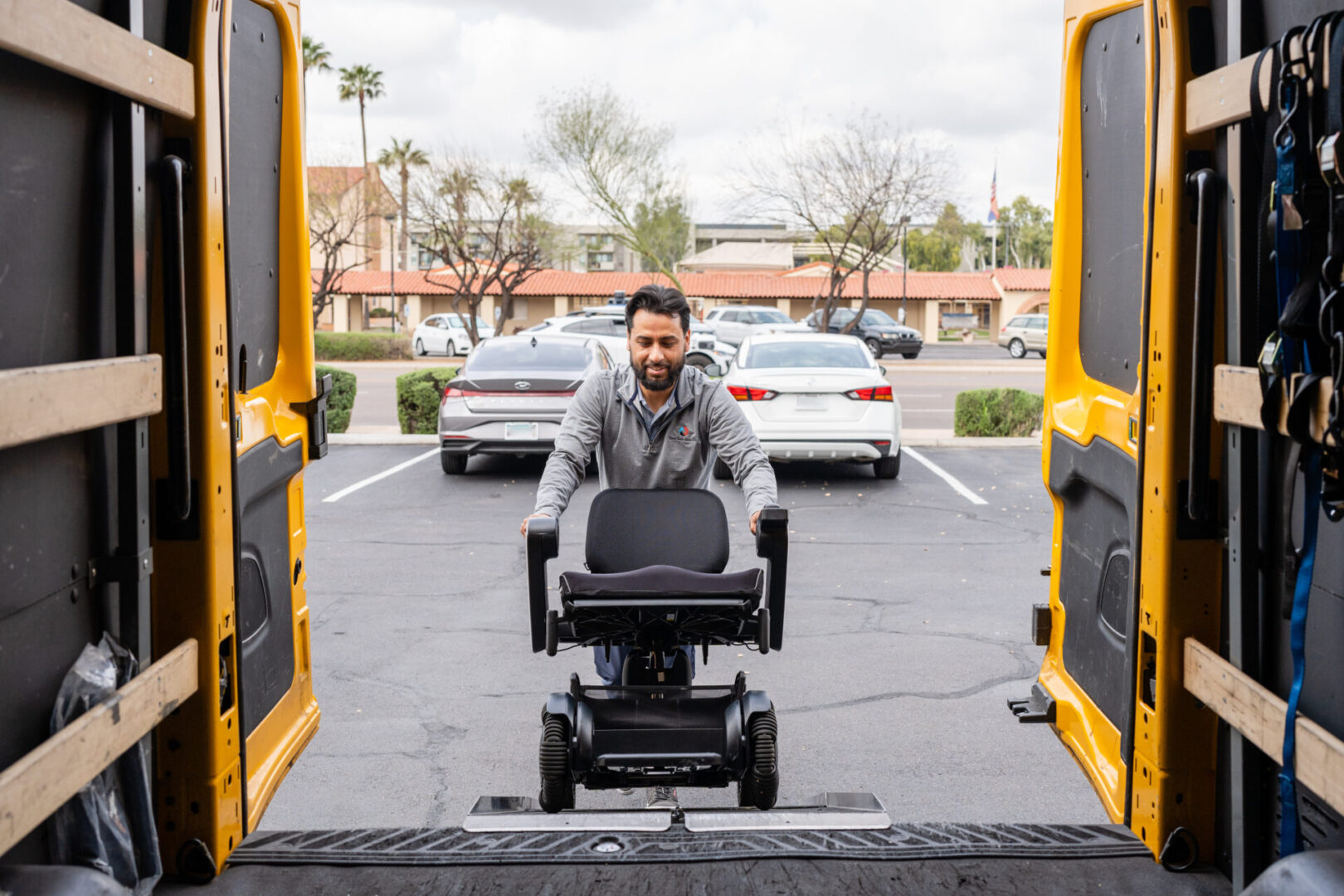 A person loading the mobility device in the truck
