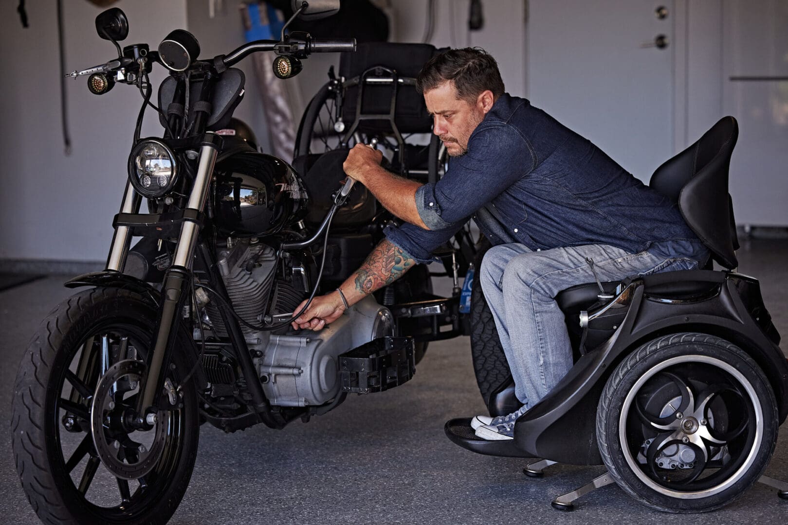 A man working on a motorcycle in a garage.