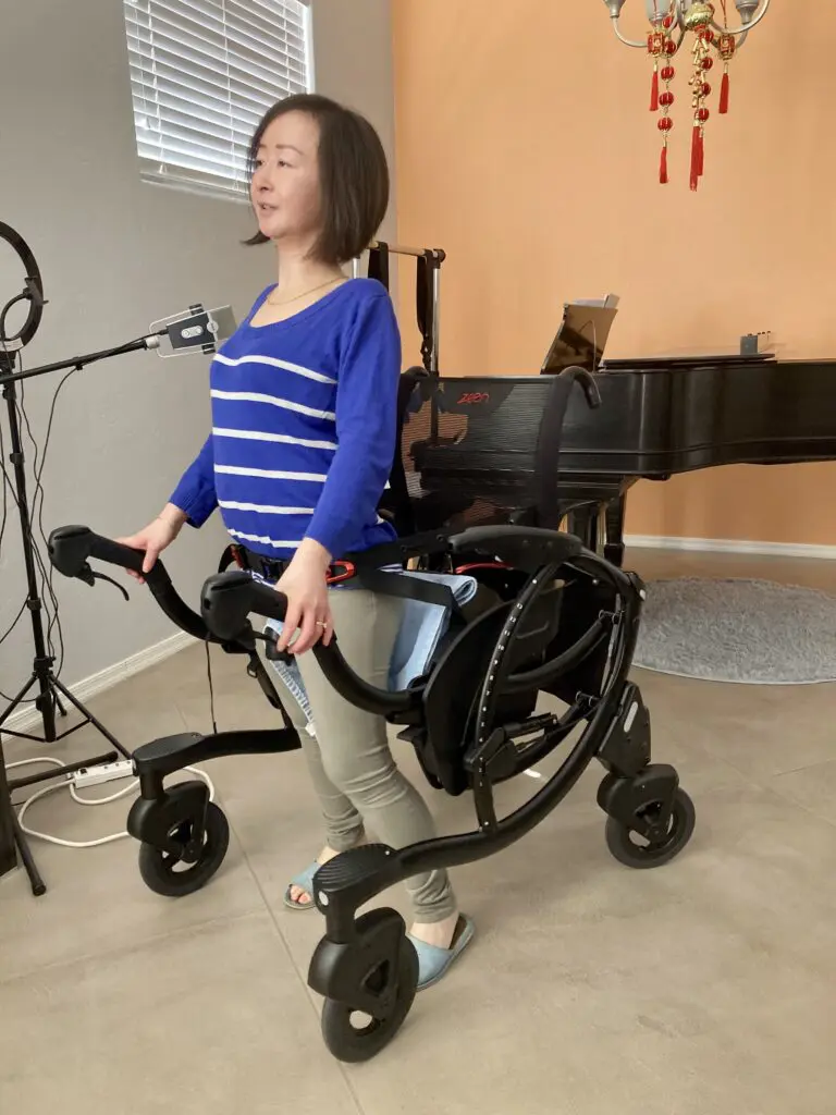 A woman in a wheelchair in front of a piano.