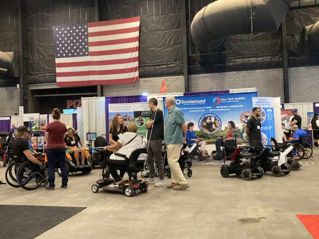 A group of people in wheelchairs at a convention.