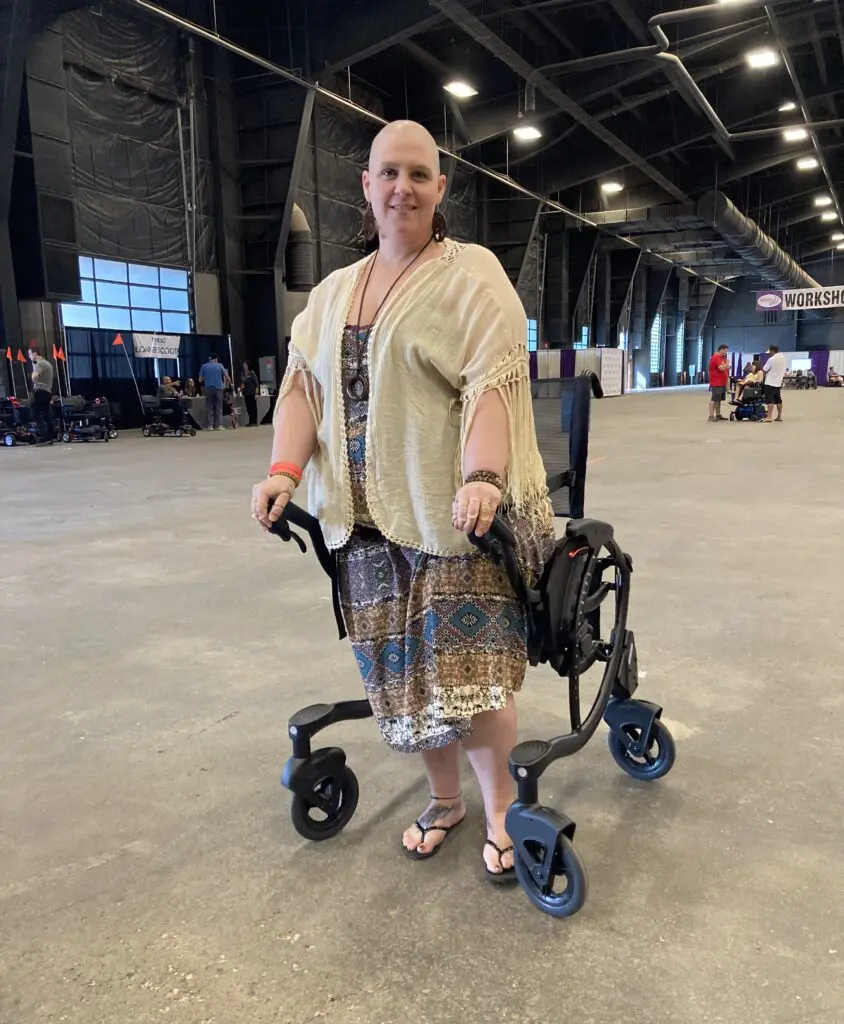 A woman in a wheelchair standing in an arena.